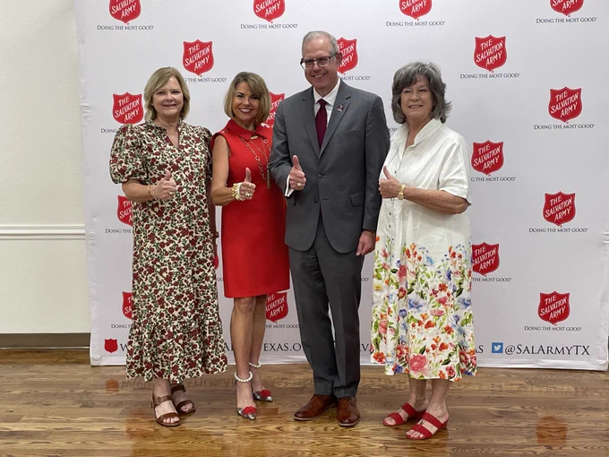 Dean Sherman posing with Jennifer Bohac and other luncheon attendees.