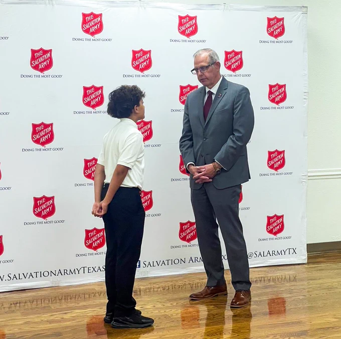Dean Sherman speaking with boy at luncheon.