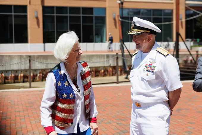 Photo of County Executive Klausmeier speaking with RADM David Faehnle, Commandant, Naval District Washington Admiral.