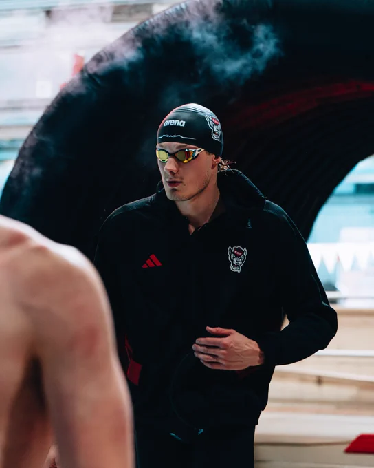 Image of Quintin McCarty walking through tunnel with googles and cap on with haze before race.