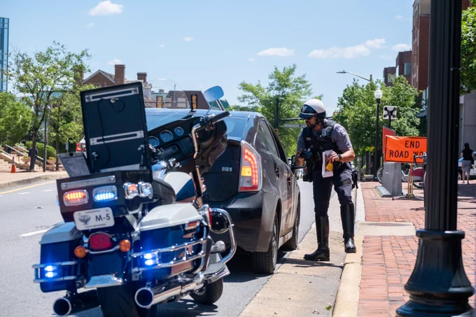 A police officer issues a warning to a driver and shares information on being Street Smart to keep pedestrians safe. 