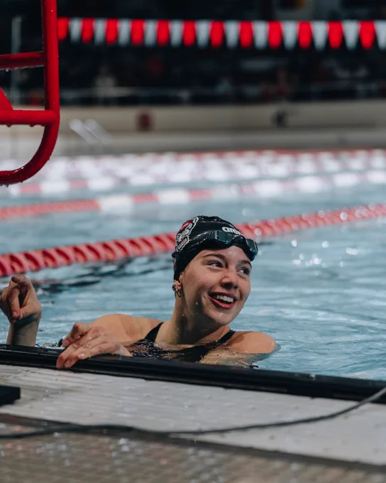Image of Leah Shackley smiling after race in pool. 