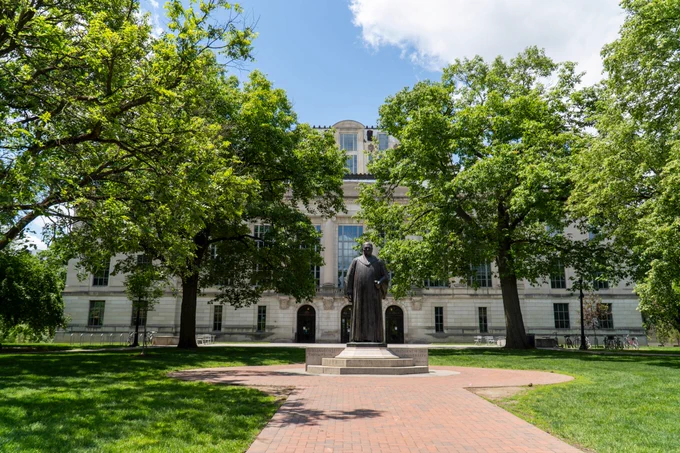 A view of Thompson Library from the Oval, a statue of William Oxley Thompson is front and center
