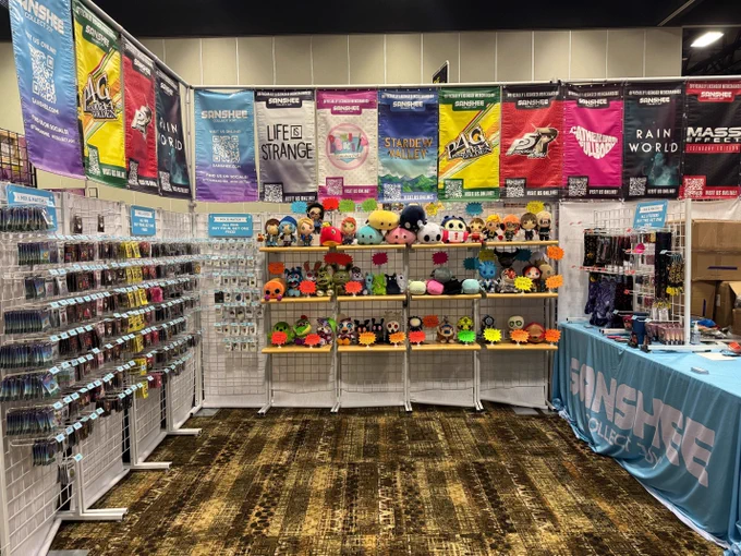 Sanshee booth at ColossalCon Prime showing numerous plushies, pins, and more at the booth