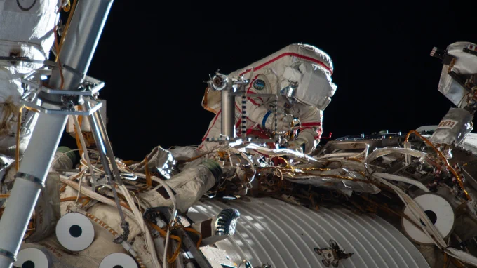 Roscosmos cosmonaut and Expedition 74 commander Sergey Kud-Sverchkov works outside the International Space Station in his Orlan spacesuit with red stripes. During the six-hour and five-minute spacewalk, Kud‑Sverchkov, along with Roscosmos cosmonaut Sergei Mikaev (out of frame), installed a solar radiation experiment and removed physics and microbiology research hardware from the orbital outpost.