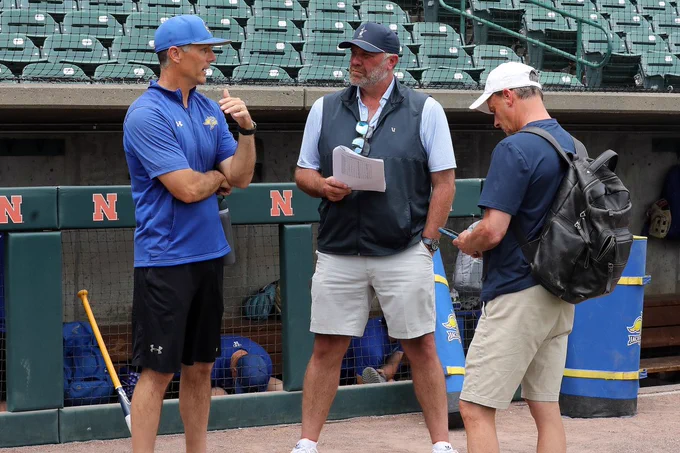 South Dakota State baseball head coach Rob Bishop (left) chats with ESPN announcers Kyle Peterson (center) and Karl Ravech (right) during the team's practice May 28, 2026, in preparation for NCAA Regional action at Hawks Field in Lincoln, Nebraska.