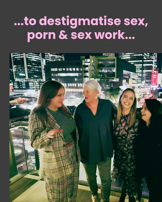 Black slide with blush writing: "...to destigmatise sex, porn & sex work..."
Photo of group with Perth skyline in the background, four feminine bodies, from left to right:
Jenna Love, Scarlet Alliance president, Long red hair, check green suit and t shirt, talking and waving her left hand.
Feminine bodied person with grey hair tied back, smiling and facing Jenna, body facing forward, wearing a black large shirt, khaki pants and sneakers.
Feminine bodied person staring at the camera smiling with mouth open, blonde hair dark roots, patterened dress and black boots.
Giselle Woodly, black hair, dressed in black, feminine bodied, face towards Jenna, smiling, talking, mouth open.