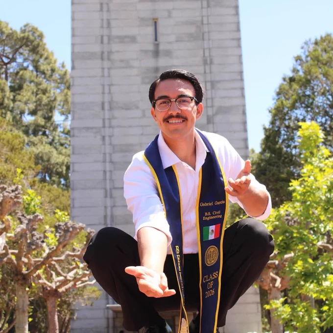 A UC Berkeley graduate poses as Spiderman ontop of 4.0 Ball while wearing a graduation stole. @gvbriel.gvrciv on Instagram