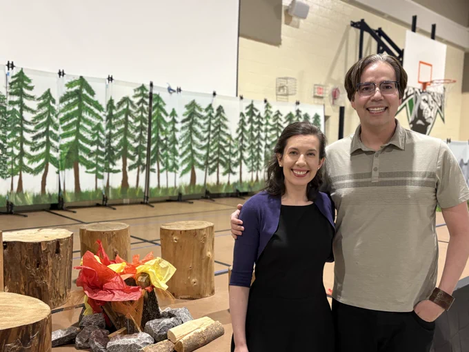 Rob Hunter & Stephania Romaniuk in front of the set of Rooted in Belonging.