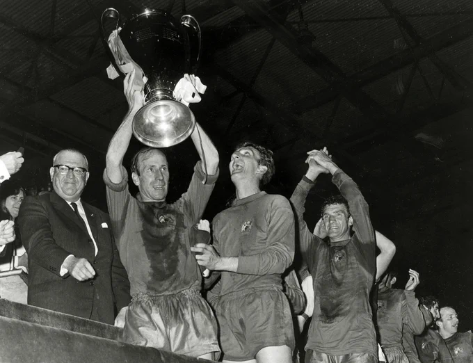 Bobby Charlton celebrates as he lifts the European Cup in a crowded Wembley Stadium after the 1968 final.
