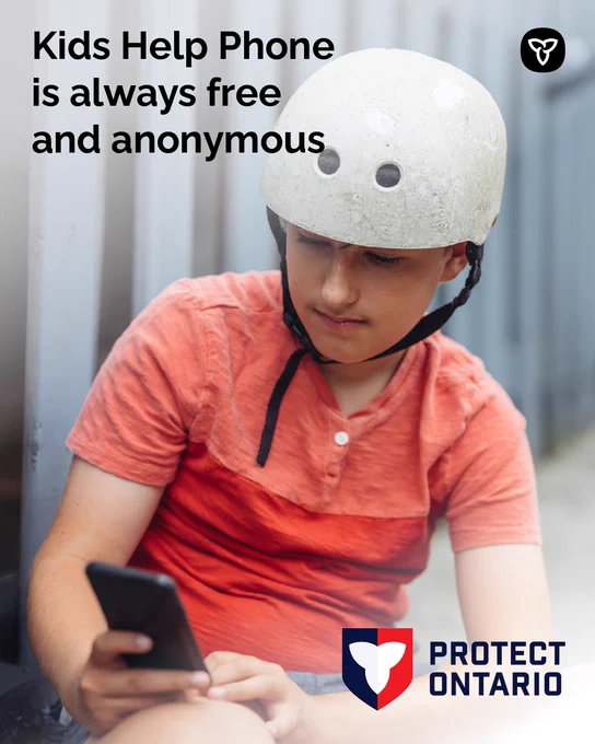 Young person wearing a helmet looking at a phone; message: Kids Help Phone is free and anonymous. 