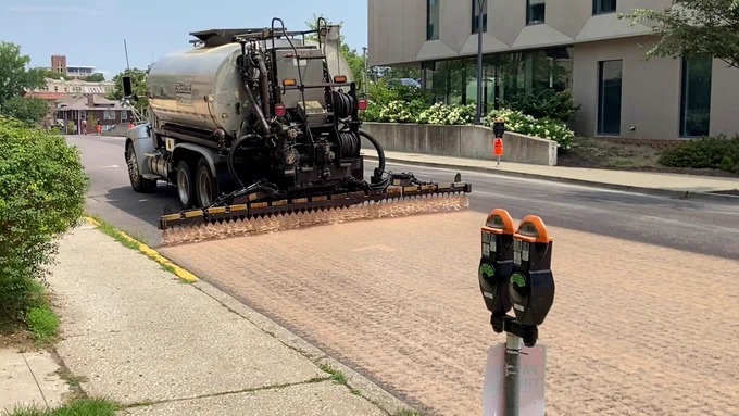 A CAM LLC truck applies Reclamite to Hitt Street in 2024.