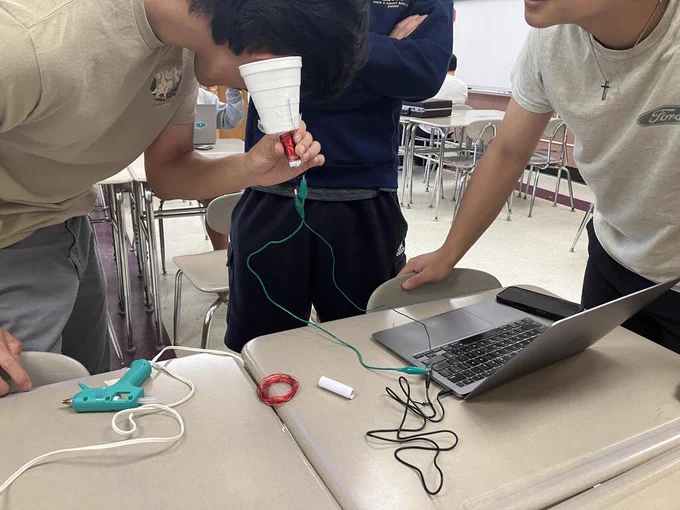 Student with speaker he built.