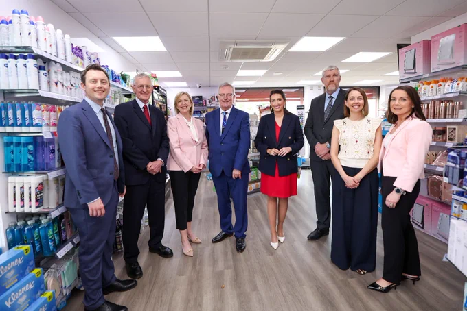 Photo of eight people standing inside Carryduff Pharmacy.