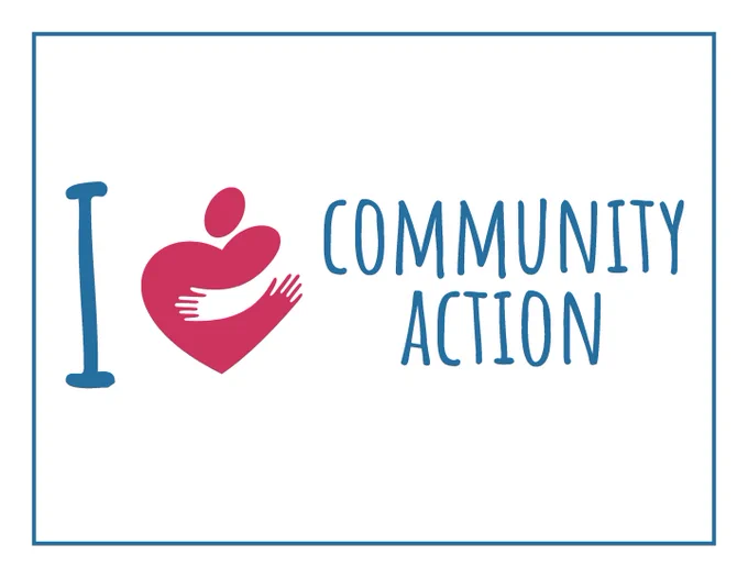 A sign that reads, "I love Community Action," where the word love is replaced with the agency's "Huggy Heart" logo.