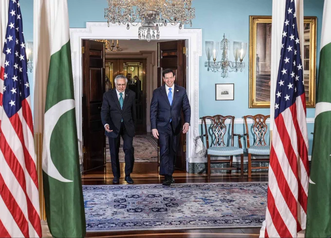 Secretary Rubio walks into a room with Pakistani Deputy Prime Minister and Foreign Minister Dar through a doorway with wooden doors in Washington, DC on May 29, 2026. They walk across a rug in a room with wall sconces, a framed painting on the wall, a chandelier hanging from the ceiling, and wood chairs to the side of entrance. (State Department/Freddie Everett)