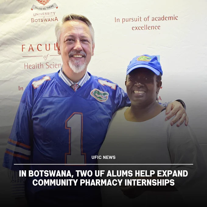 Two University of Florida alumni stand together at the University of Botswana Faculty of Health Sciences event promoting pharmacy internships.