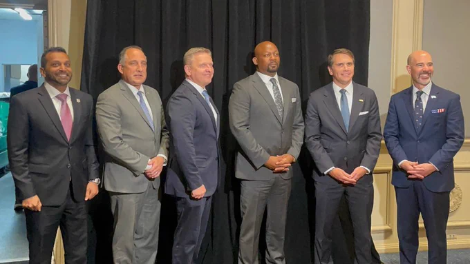 Moderator Markel Hutchins (pictured in the center) and panelists at the 2026 PLECET National Conference, including DEA Administrator Cole (pictured far right) and FBI Director Kash Patel (pictured far left).