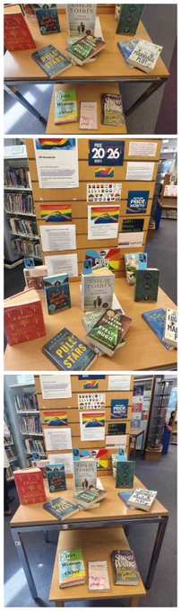 A table displaying various books and posters for Pride Month

