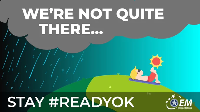 Image shows a guy sunbathing on a hill on the right side of the screen, while clouds and rain darken the left side of the screen. Text says "We're not quite there... Stay #ReadyOK"