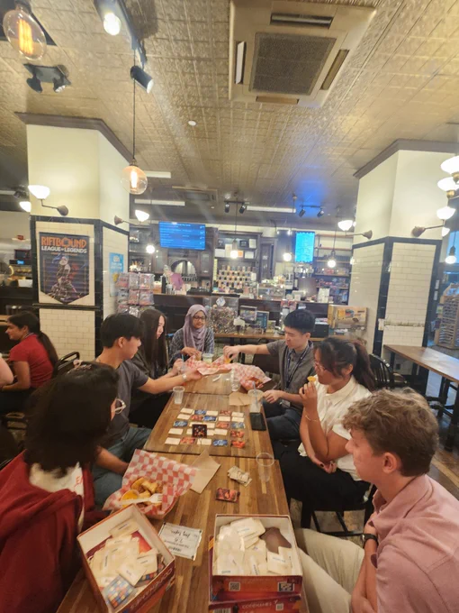 SRP interns at a board game lunch outing at Hex and Co, playing a game and eating lunch.