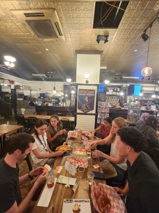 SRP interns at a board game lunch outing at Hex and Co, playing a game and eating lunch.