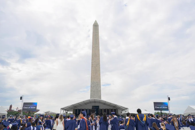 The George Washington University Commencement stage on the National Mall with the Washington Monument visible behind it.