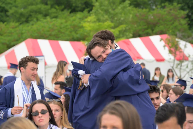 Two graduates hugging on the National Mall.