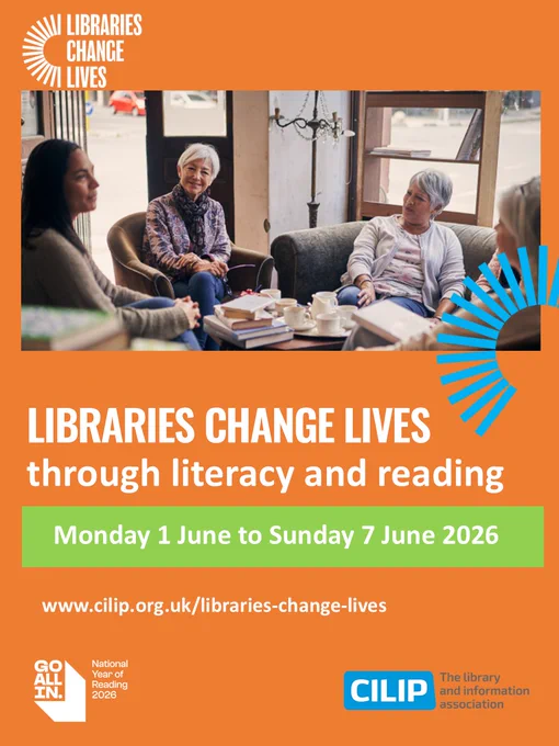 A group of adults engaged in a relaxed reading and discussion session in a library setting.