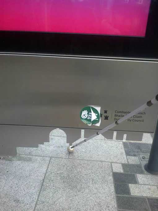 Photo (above) showing JC Decaux advertising panel on Liffey Street with long cane in jagged edge,