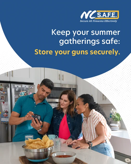 Three adults gathered together in a kitchen and looking at a phone. Text reads: "Keep your summer gatherings safe: Store your guns securely."