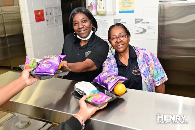 Summer Meals program, pictures nutrition staff handing out food.