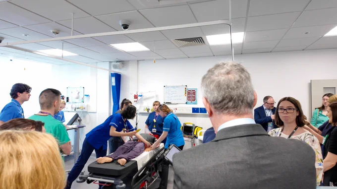 The Health Minister Mike Nesbitt watches a demonstration at the QUB InterSim Centre