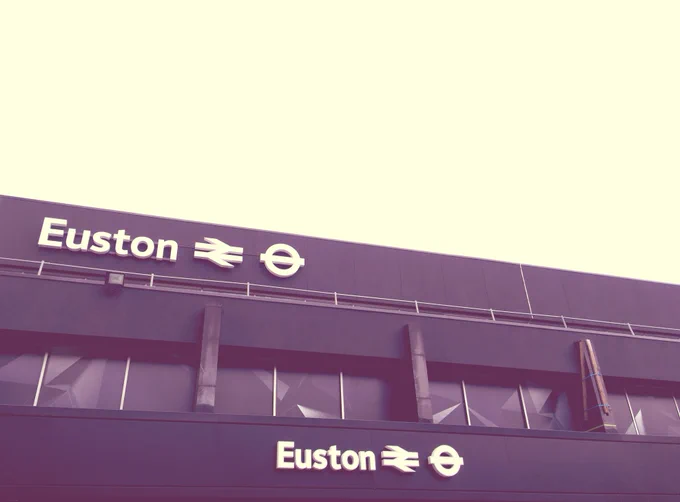 A black and white image of the Euston Station sign