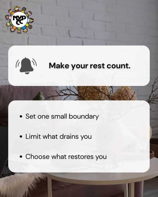 Cozy living room with a white brick wall and a round table, featuring tips to make rest count by setting boundaries and choosing restorative activities.