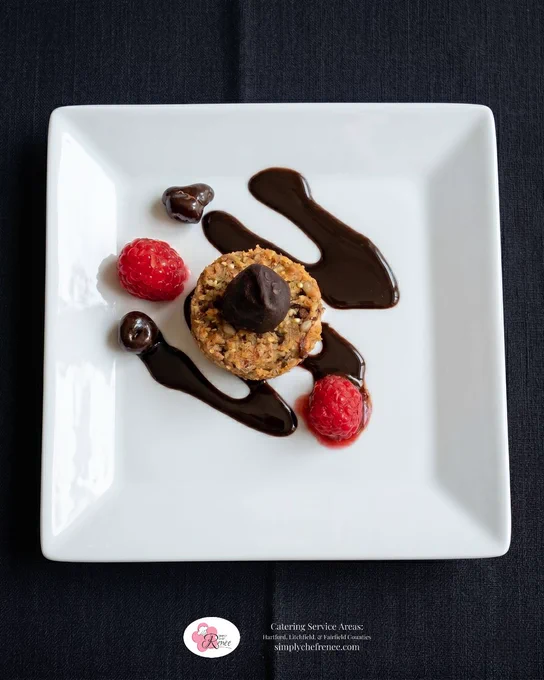 Elegant dessert plate prepared by Simply Chef Renée featuring an Aussie Bite topped with chocolate, chocolate drizzle, and fresh raspberries on a white square plate. Gourmet dessert catering option for weddings, brunches, corporate events, and private celebrations in Hartford, Litchfield, and Fairfield Counties, Connecticut.
