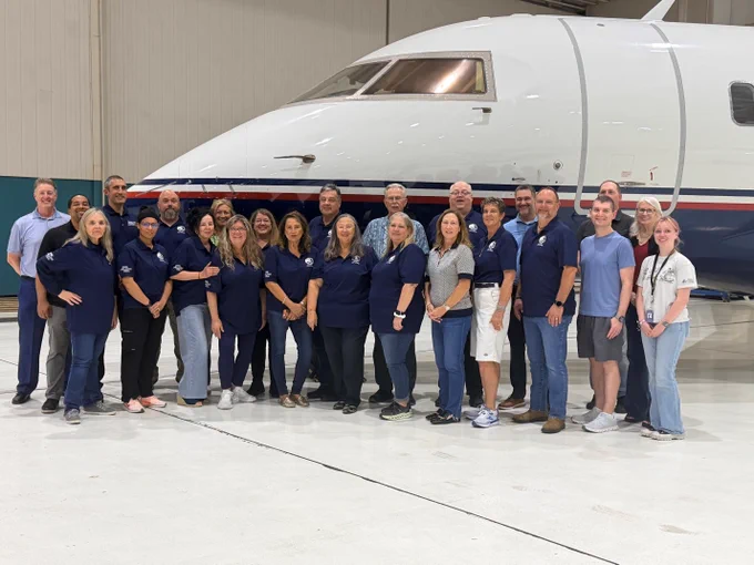 Citizen Academy members in front of large aircraft 