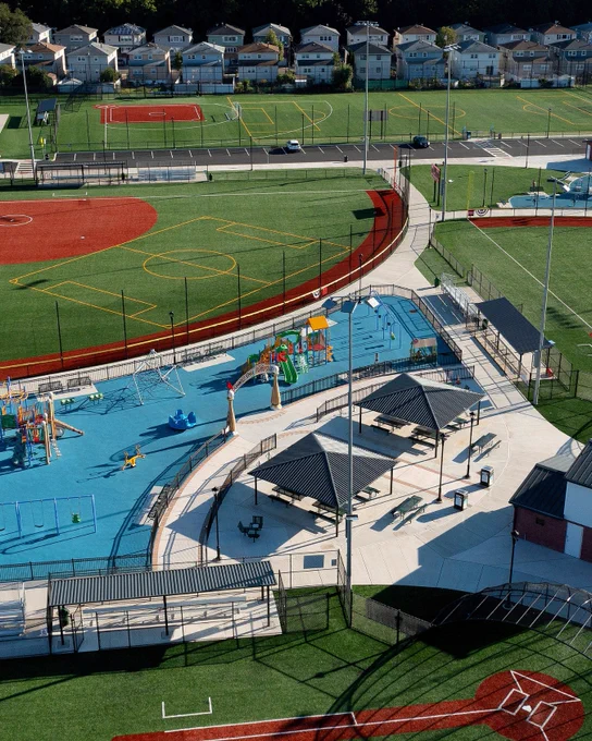 aerial shot of a multi-use sports park with a play ground and picnic seating
