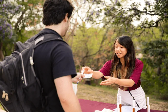 Alyssa LaGrone passes out materials to a student during a Wellness Wednesday event.