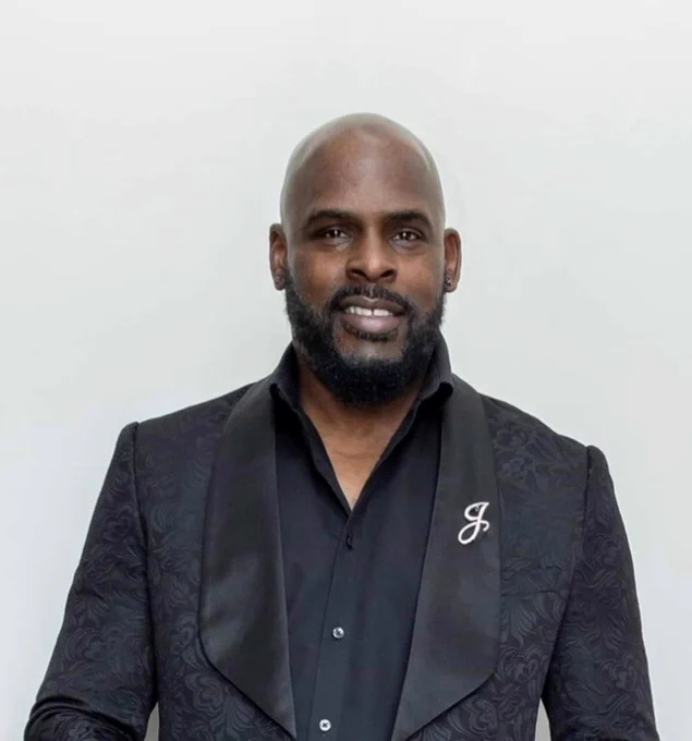 A headshot of a man in a suit