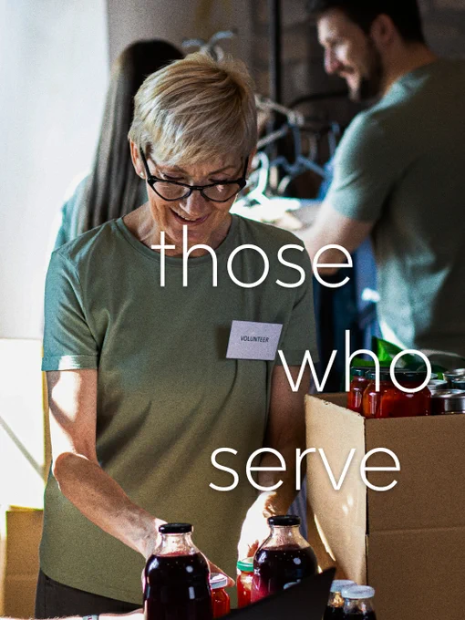 A group of volunteers sorts through jars and bottles of food donations. The image conveys community service and commitment.