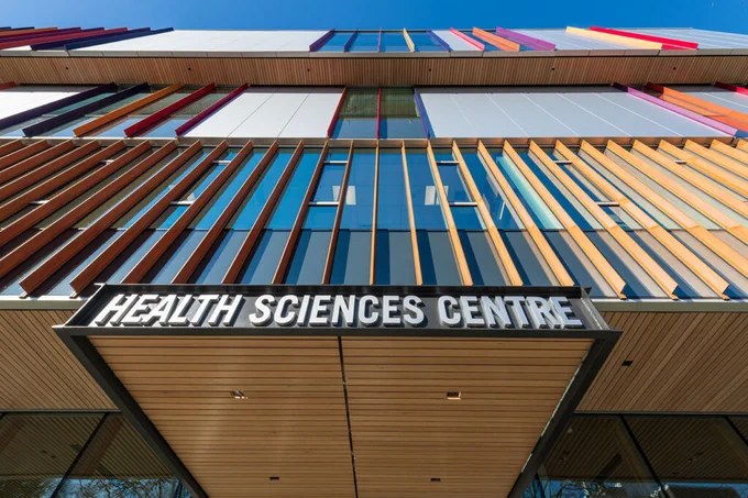BCIT Health Sciences Centre building exterior with wood fins and entrance sign. 