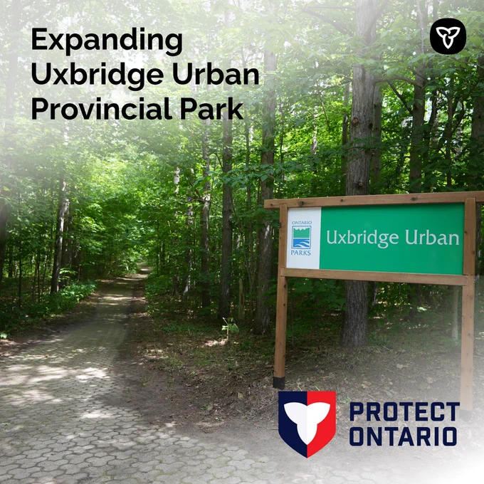 Image of the Uxbridge Urban Provincial Park sign on a path in the woods. Asset text reads "Expanding Uxbridge Urban Provincial Park".