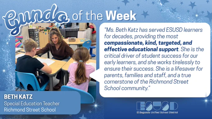 Special education teacher Beth Katz engaging with two young students at a classroom table, fostering a supportive learning environment.