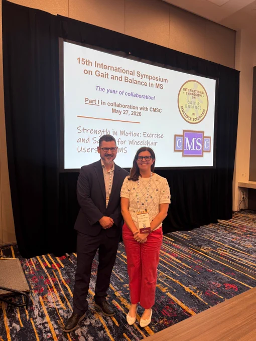 Jake Sosnoff and Laura Rice in front of presentation projector at the Consortium for MS Centers (CMSC) conference on falls in MS.