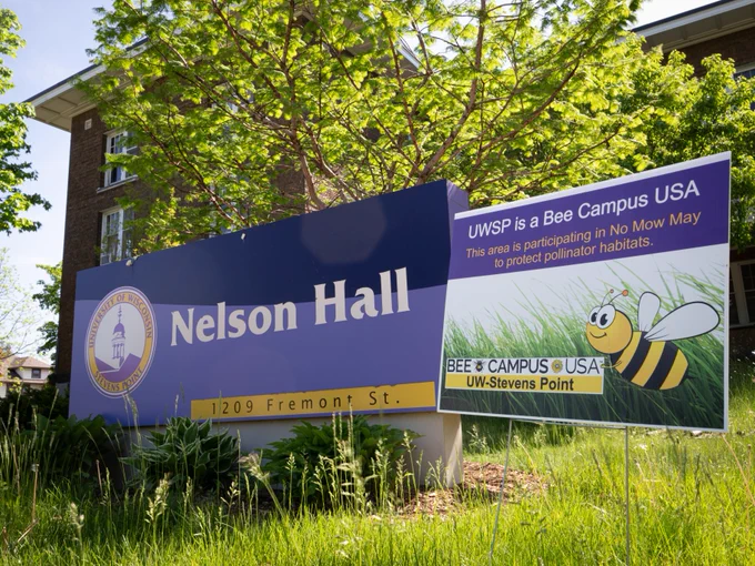 Nelson Hall with a Bee Campus USA sign