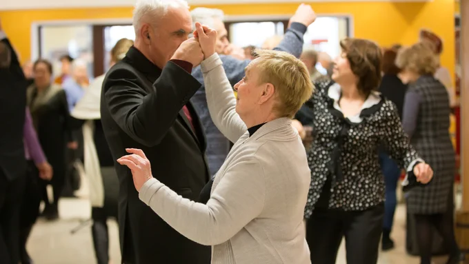 Older adult swing on the dance floor during a community dance. 