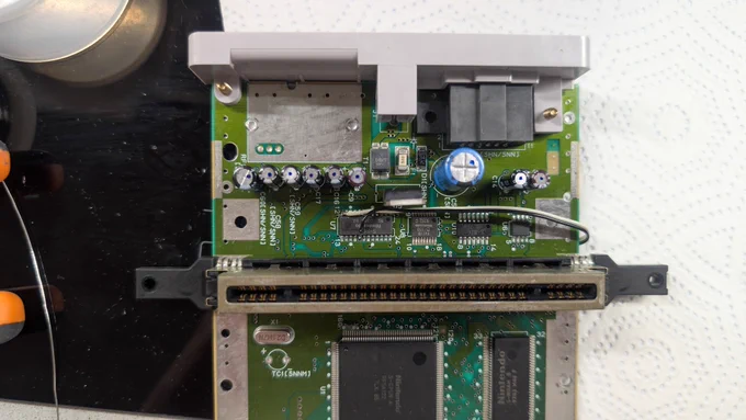 Super Famicom Jr. SHVC-101 motherboard fully restored: new electrolytic capacitors, replaced 7805 voltage regulator, Borti4938 RGB bypass board installed, and the component swaps for the brightness and ghosting fixes all soldered in.