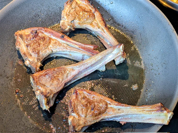 Four cutlets browning in the pan. 