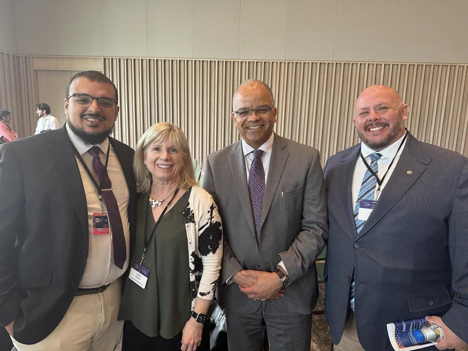 Four people at the Health Equity Summit pose for a photo.
